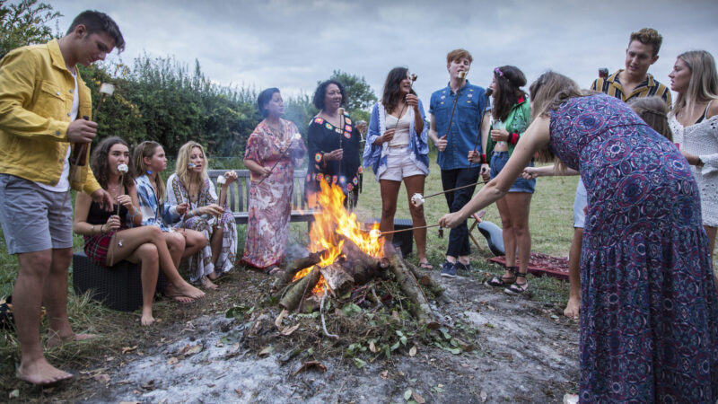 Friends at bonfire party in park