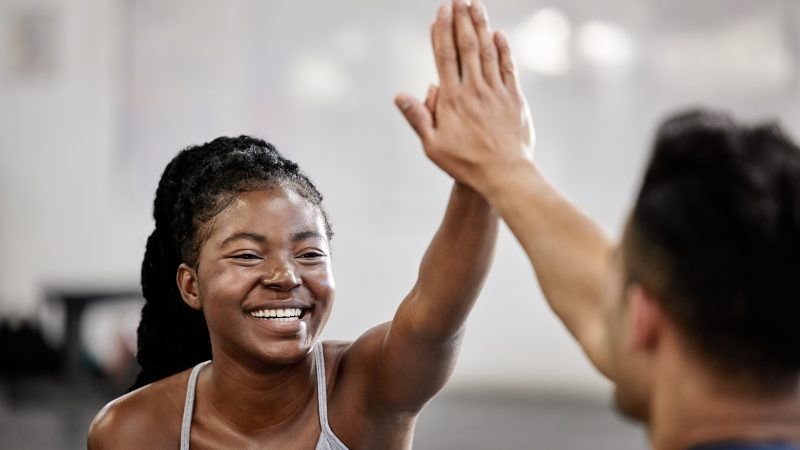 High five, fitness team and gym success of friends in happy exercise workout together for health an.