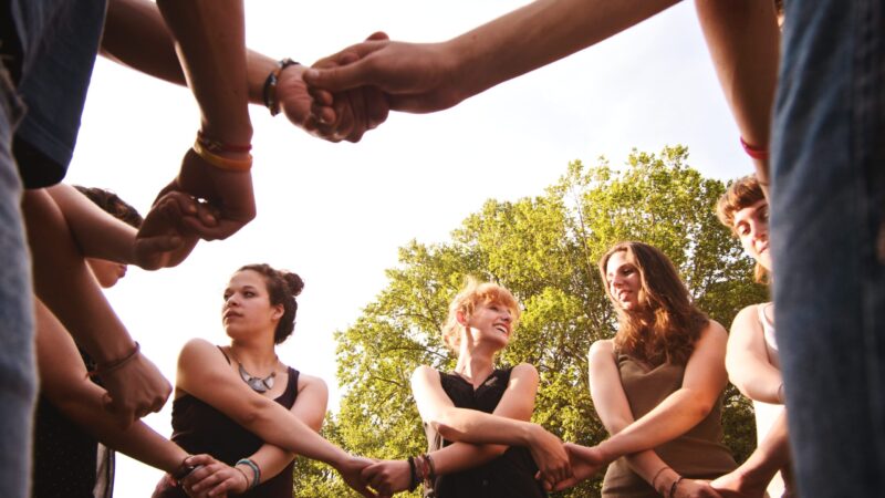 large group of friends enjoying a summer day at the park, back to school