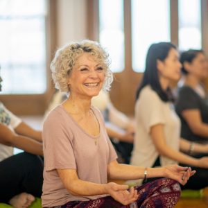 Diverse group of adults at a group fitness yoga class.